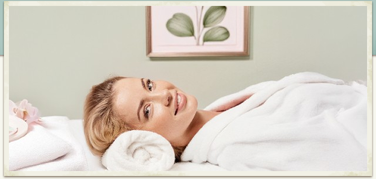 blonde woman laying for body treatment