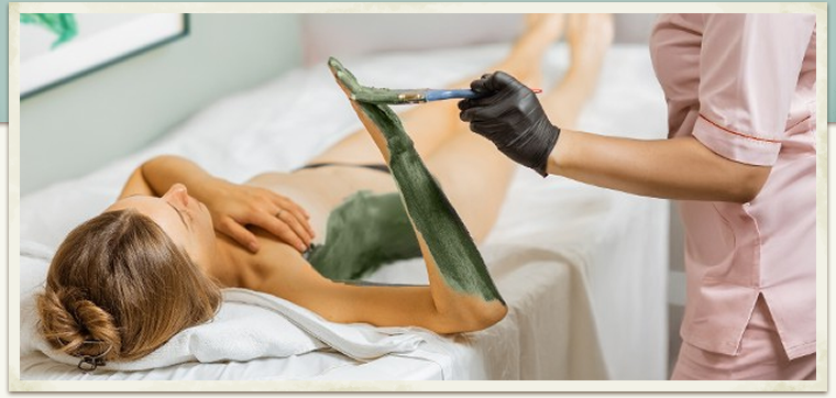 seaweed body treatment on woman on table